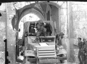 Command car passing through Lions’ Gate behind the advance attack force